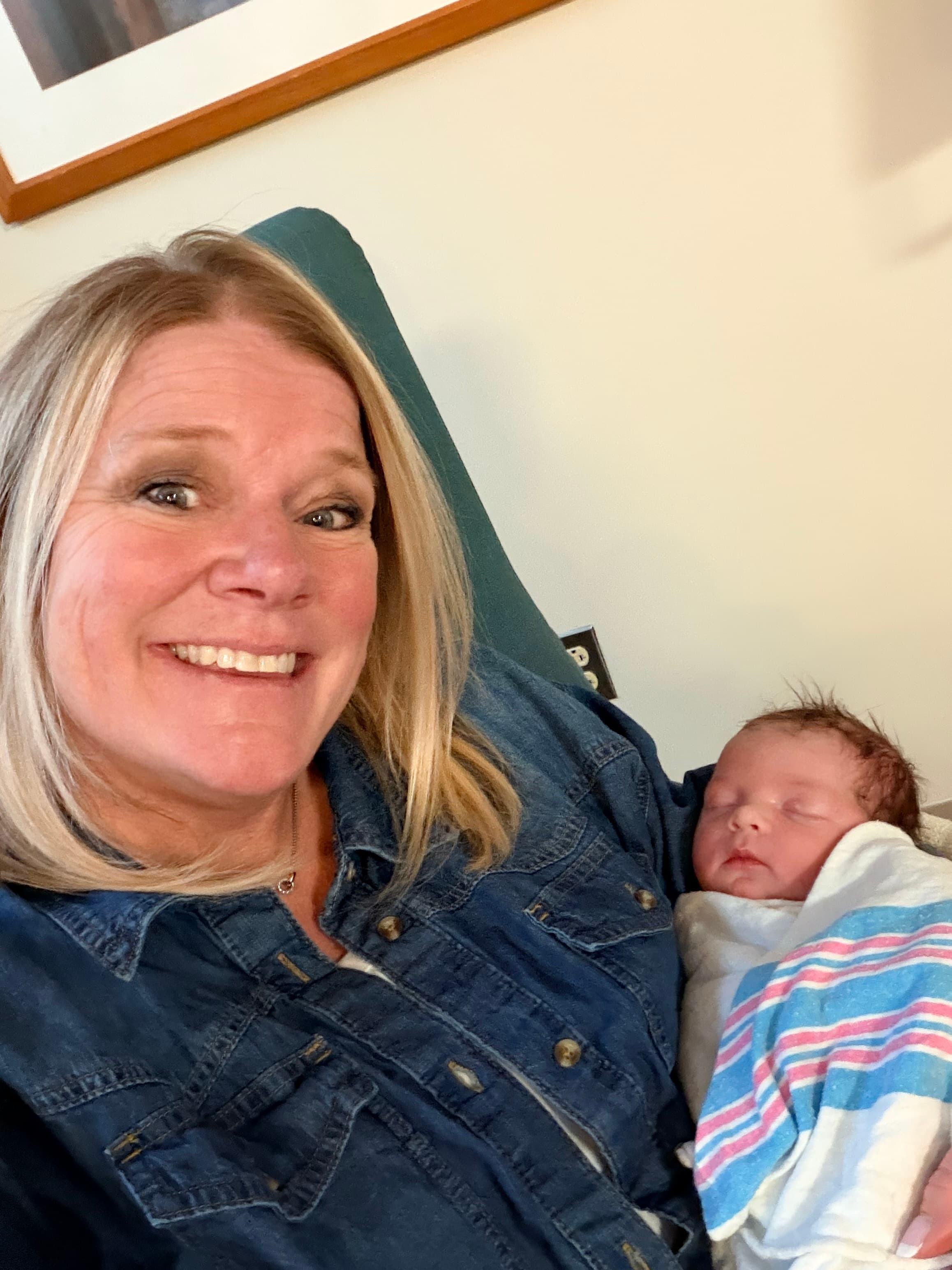 Farrell Kelly holding a newborn