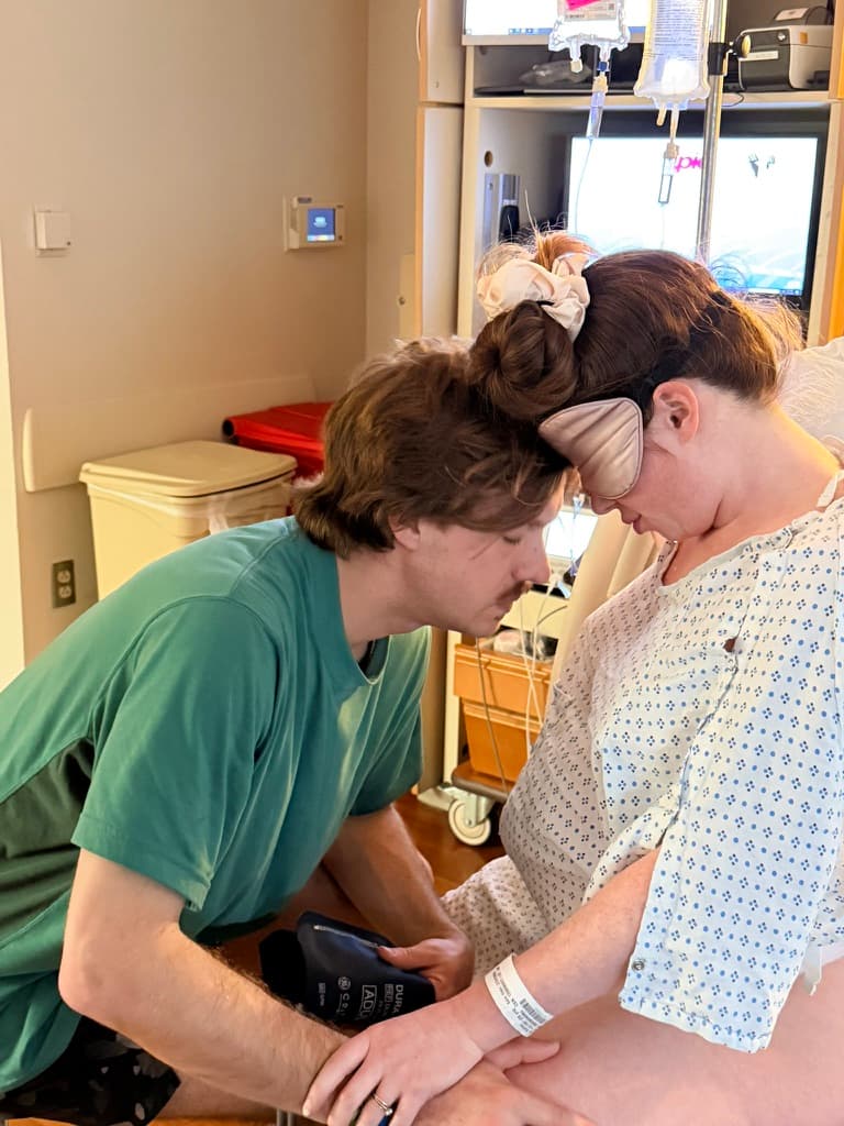Partner supporting laboring mother during birth